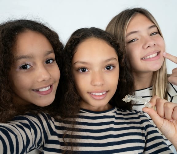 Group of teens showing off their straight teeth